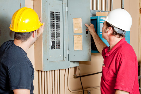 image of hvac technician checking furnace circuit