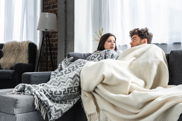 couple experiencing a cold spot in their house