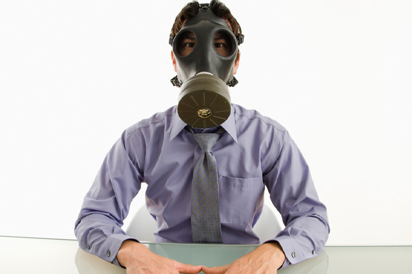 image of a man wearing a gas mask to avoid indoor air pollution issues