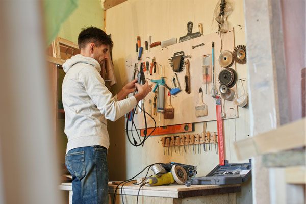 man working in garage with ductless mini-split