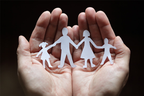 image of paper cut-out of family in hands depicting furnace safety