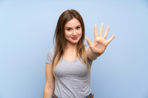 woman holding 5 fingers up depicting Five Common Misconceptions About HVAC Services