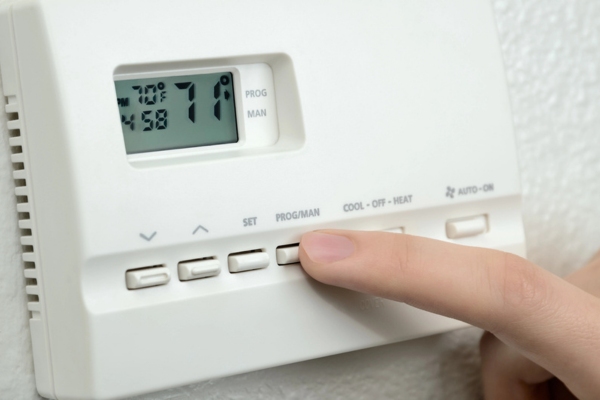 homeowner setting programmable thermostat