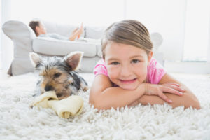 girl on carpet depicting indoor air quality