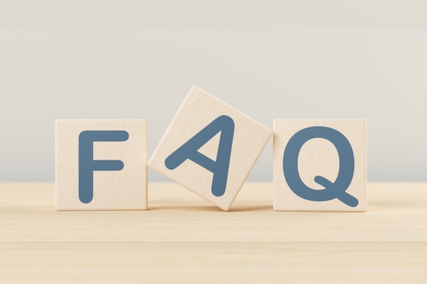 FAQ spelled using wooden letter cubes depicting questions about functionality of ductless air conditioners
