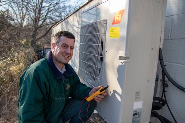 McAllister Energy HVAC technician servicing the outdoor unit of ductless AC