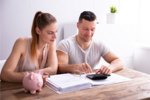 image of couple calculating savings after air conditioner maintenance