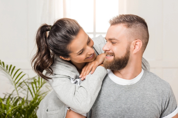 wife leaning on husband depicting homeowner confidence due to regular AC tune-up