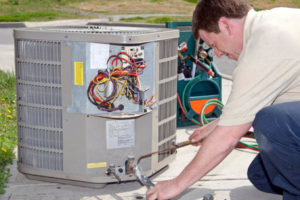 image of an hvac contractor performing air conditioner replacement