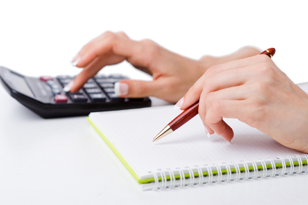 image of hands and calculator calculating ac seer efficiency rating