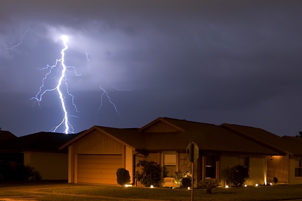 house with power at night during a power outage and backup generator