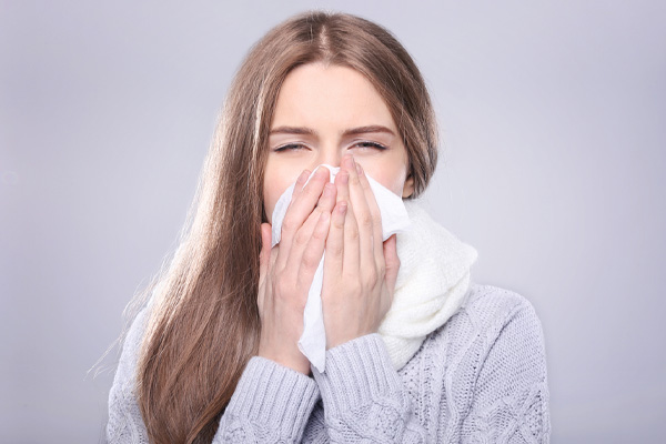 image of homeowner with allergies dealing with dry air in winter