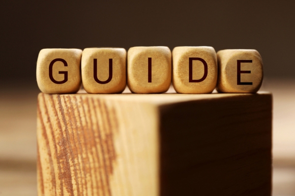 Word Guide made of cubes on wooden block depicting standby generator size