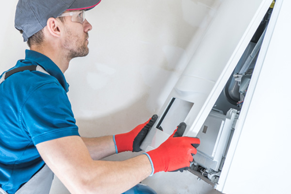 image of a hvac contractor installing a heating oil furnace with higher efficiency