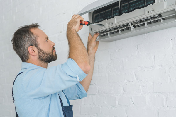 image of an hvac contractor performing a heat pump repair