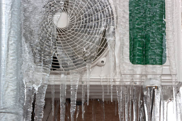 heat pump covered in ice during winter