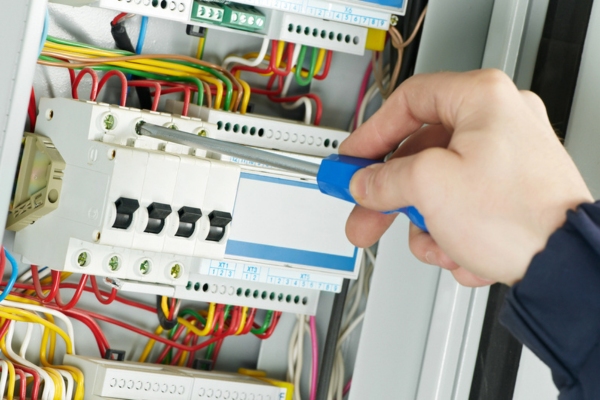 electrician repairing circuit breaker box due to air conditioner tripping circuit breaker