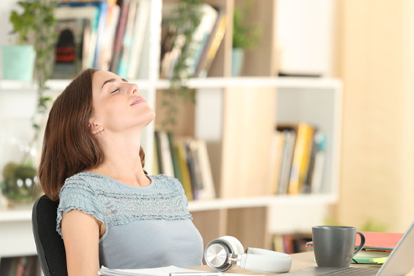 image of a homeowner breathing deeply due to healthy indoor air quality