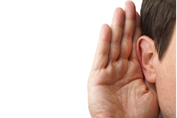 image of a homeowner listening for noises coming from air conditioner