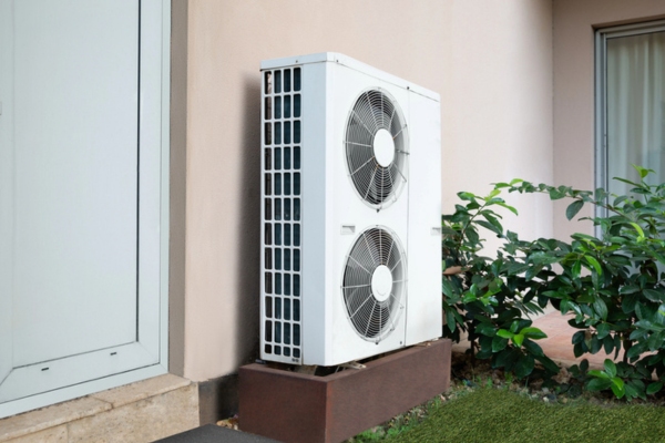 outdoor ductless AC unit installed beside the plants