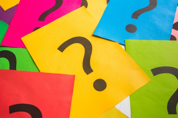 question marks on colored paper depicting Air Conditioning for Old Houses FAQs