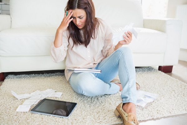 woman with tablet pc calculating expensive energy bills