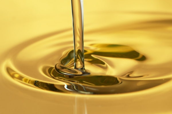 pouring gold liquid depicting fuel oil additives