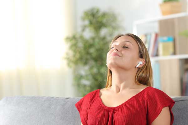 image of a homeowner on couch breathing deep due to mechanical ventilation benefits