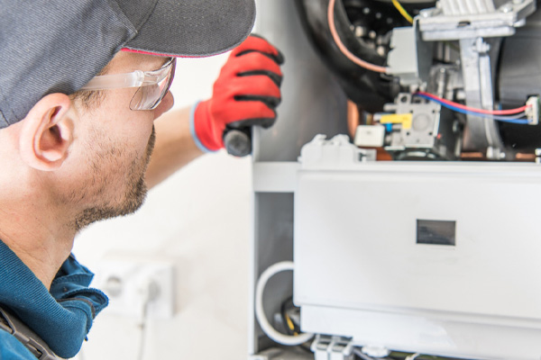 image of an hvac contractor performing a gas furnace repair