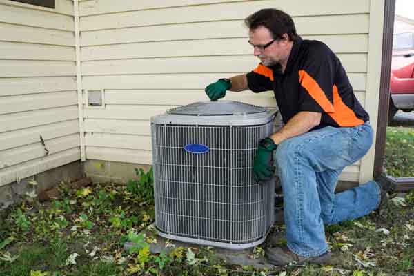 image of an hvac contractor performing a heat pump fan repair