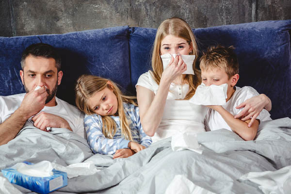 image of a sick family on bed depicting poor iaq