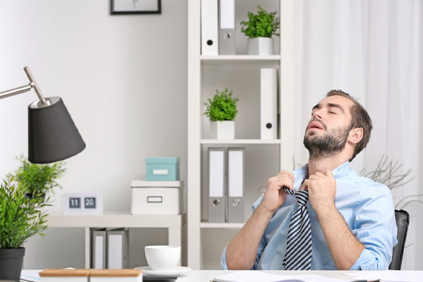 image of a man feeling hot and uncomfortable due to ac capacitor failure