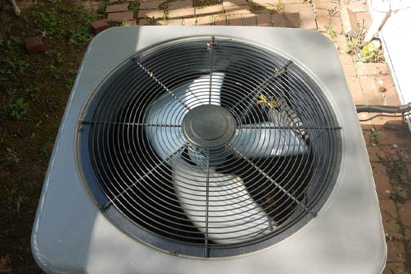 image of an air conditioner compressing unit with a broken fan