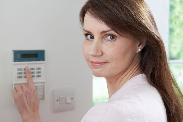 image of a woman setting security system depicting power generators for home