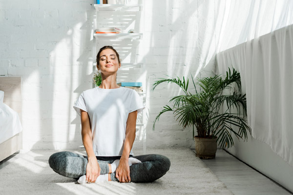 homeowner doing yoga depicting home comfort and hvac