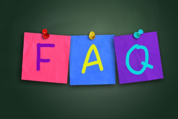 FAQ written on colored paper pinned on a board depicting questions about air conditioner replacement