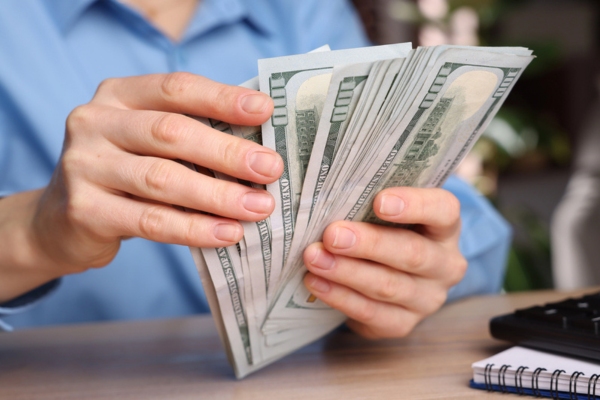 homeowner counting money depicting AC installation costs