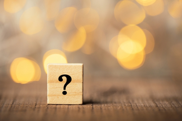 question mark on wooden chips depicting FAQs about what to expect during an AC installation