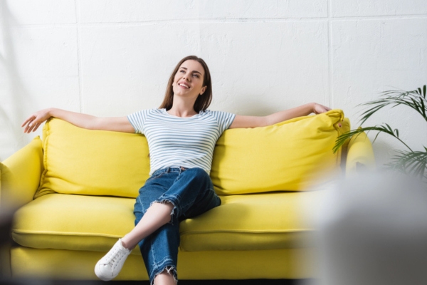 woman keeping cool indoors because of an air conditioner