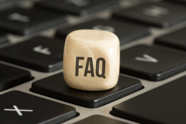 FAQ on a wooden dice depicting questions about Air Conditioning scams