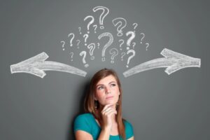 Woman making a decision with arrows and question mark depicting forced air vs hydronic heating systems