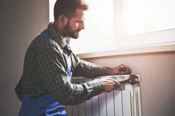 professional technician preparing radiator for the cold weather