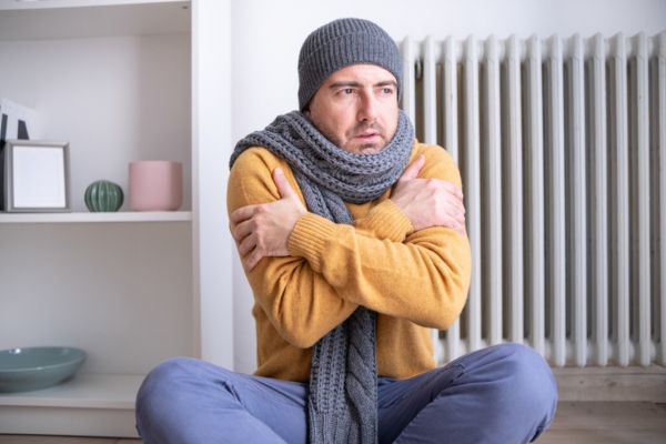 man feeling cold indoors due to cold spots in the house
