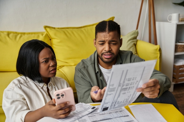 couple reviewing documents at home to Determine Cold-Season Oil Consumption