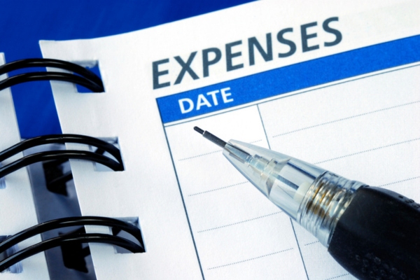 expenses written on a notebook with a mechanical pencil close up