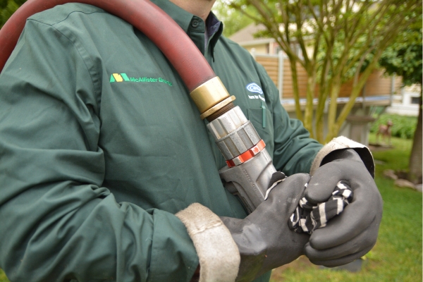 McAllister Energy oil delivery truck hose and delivery personnel