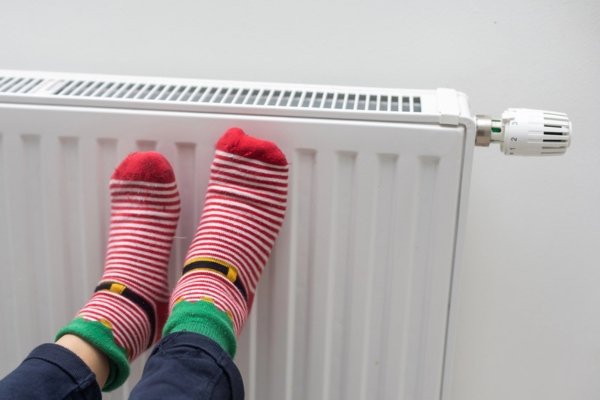 kid's feet wearing socks while keeping warm in a home heating radiator