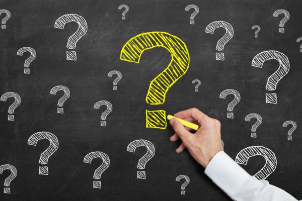 question marks doodled on a chalkboard depicting Local Heating Oil Provider FAQs