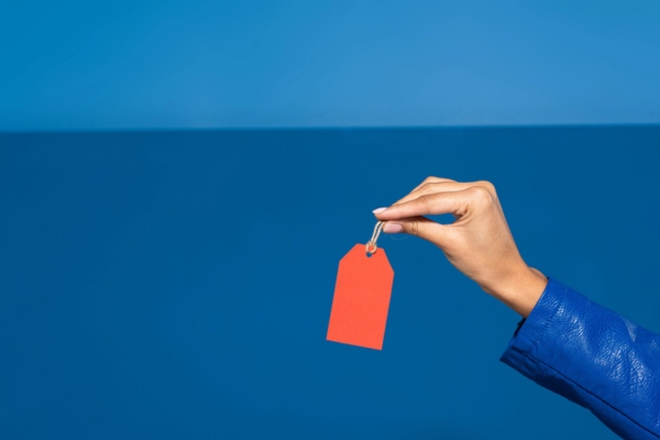 woman's hand holding an empty price tag depicting HVAC Installation Prices