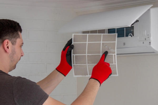 technician examining AC filter